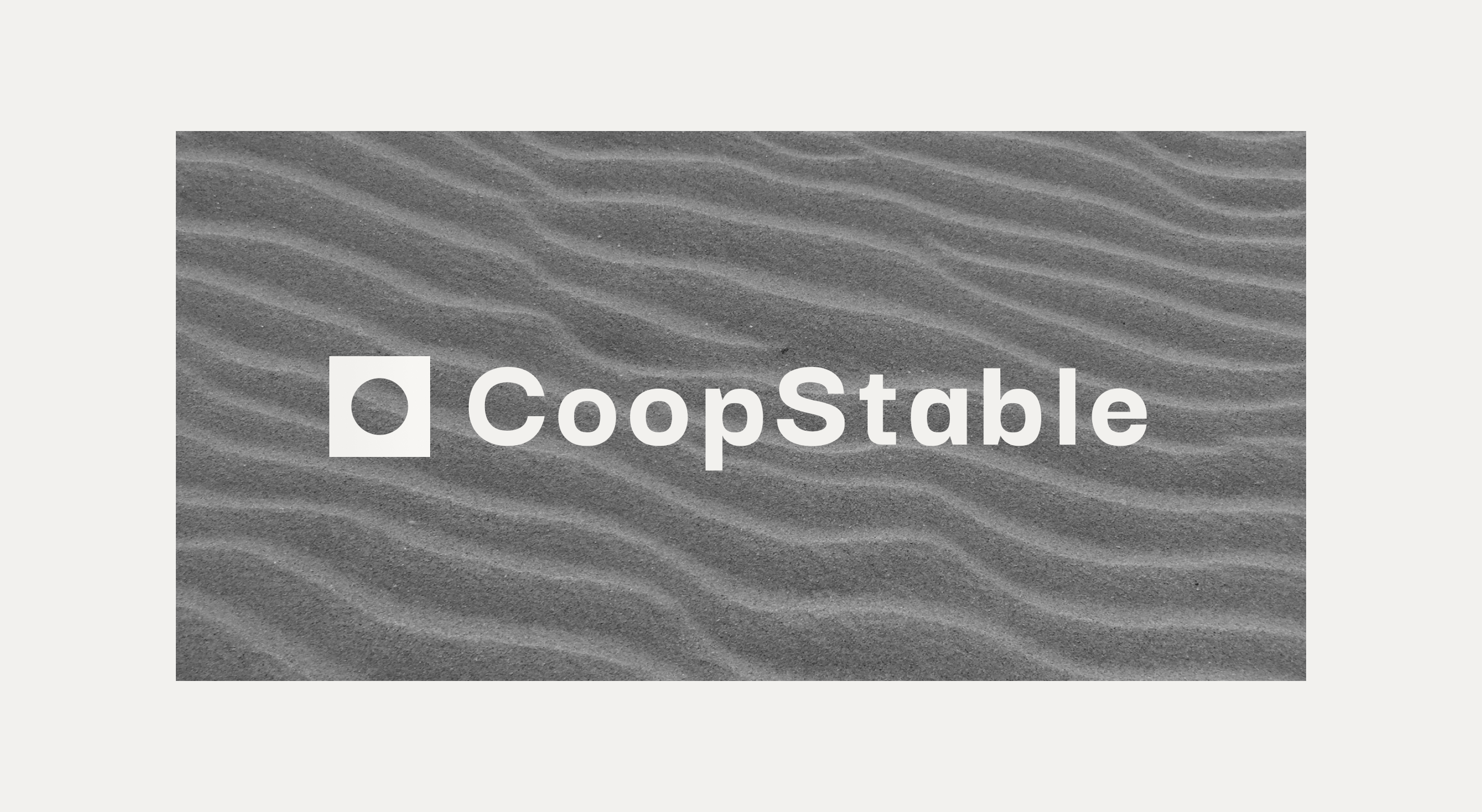 CoopStable logo on textured gray sand with wave patterns